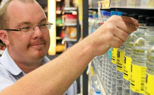 IGA Warwick’s Steve Pond makes sure bottled water is in full supply ahead of the Warwick fluoridation.